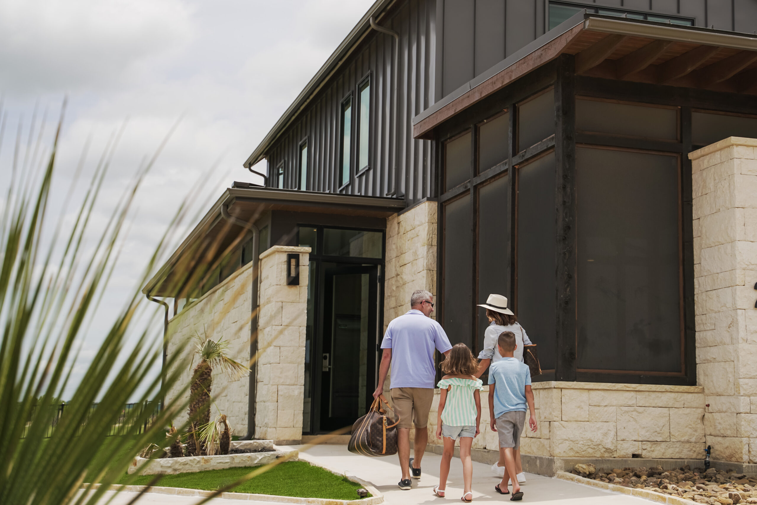 A family walking into a residential building.